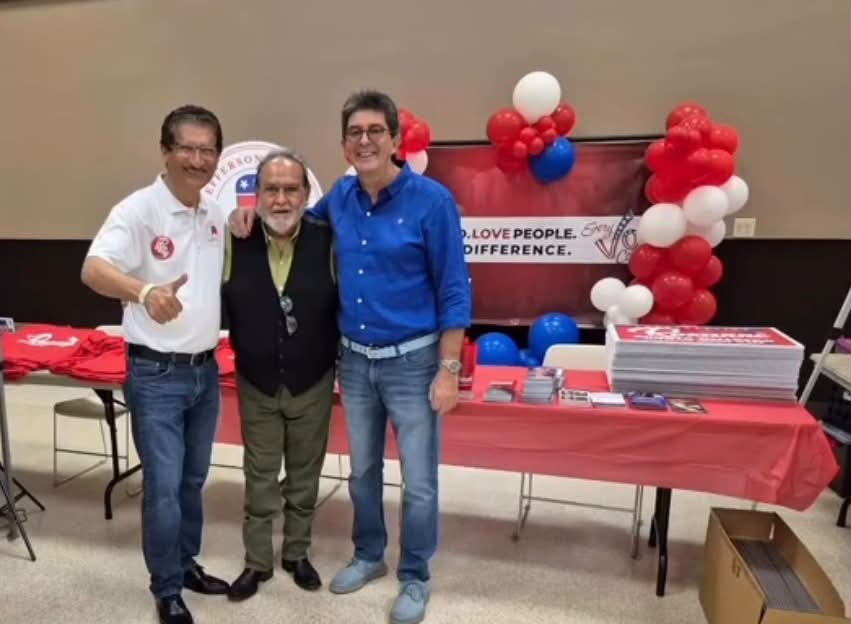 Visitors beside the PAC outreach table at Fiestas 58